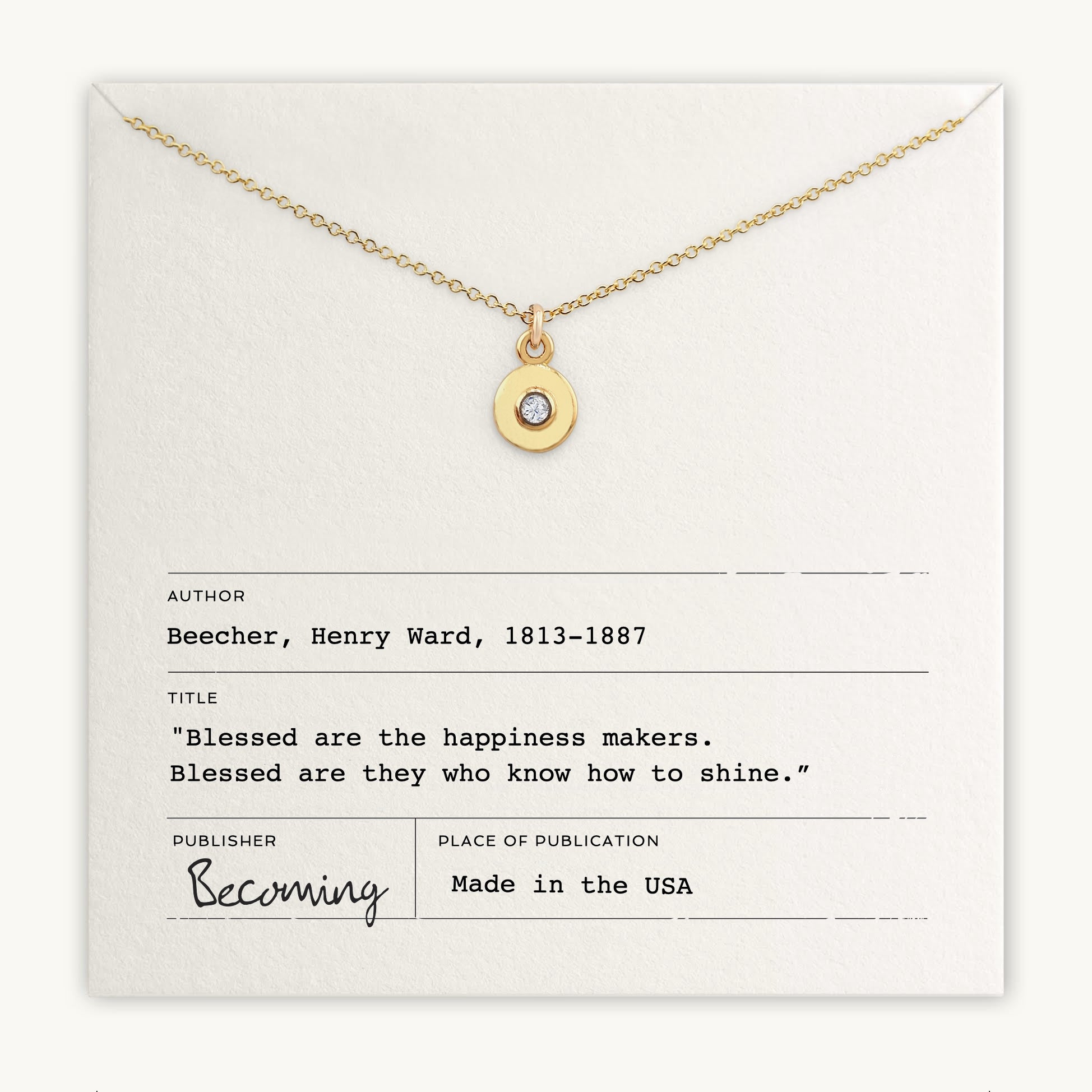 The Shine Necklace by Becoming Jewelry features a round pendant adorned with a small, sparkling Cubic Zirconia gem. It comes placed over an envelope-style card containing a quote by Henry Ward Beecher titled "Blessed are the happiness makers." Made in the USA.